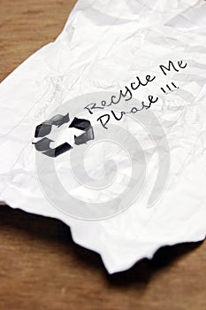 Crumpled used paper with recycle sign