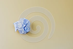 Crumpled white paper ball on light background