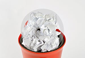 Crumpled white papers in a plastic trash can  on white