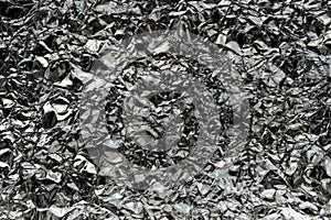 Crumpled wrinkled silver foil texture. Rumpled dark silver foil texture background