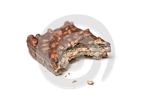 crunched chocolate bar with puffed rice on white background photo