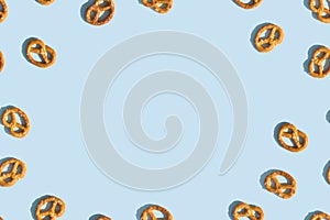 Crunchy Brezeln or salted Pretzel on blue background with copy space. Top view, flat lay. Traditional snack for Octoberfest