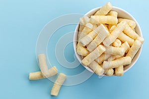 Crunchy corn puffs, pufuleti in white bowl - top view