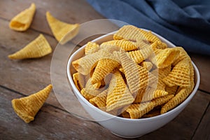 Crunchy corn snack in white bowl