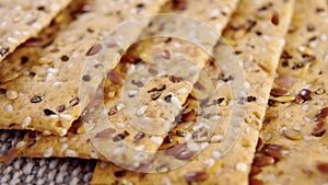 Crunchy crispbreads with falling sesame and flax seeds.