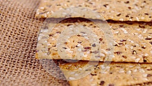 Crunchy crispbreads with sesame and flax seeds. Healthy dietary meal. Macro.