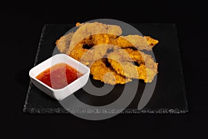 Crunchy fried onion rings with sauce