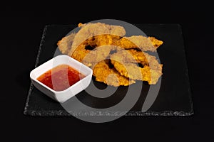 Crunchy fried onion rings with sauce photo