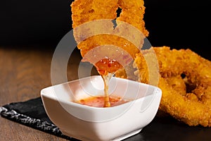 Crunchy fried onion rings with sauce photo