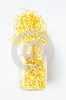 Crunchy Lemon Bhel spilled out and in glass jar, made with Puffed Rice small besan sev.