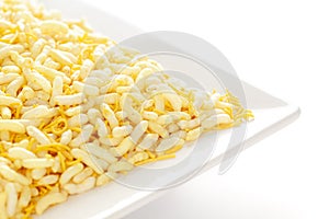 Crunchy Lemon Bhel in a white ceramic square plate made with Puffed Rice small besan sev.