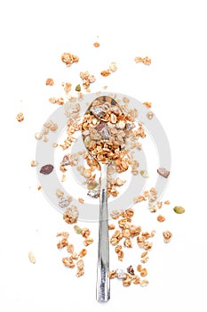 Crunchy muesli on a spoon Breakfast cereals isolated on a white background, selective focus, top view