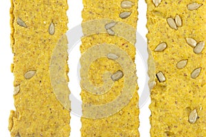 Crunchy oat thins with sunflower forming pattern on white