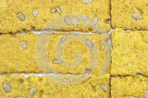 Crunchy oat thins with sunflower forming pattern on white