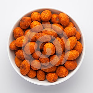 Crunchy Peanut in a white Ceramic  bowl, made with besan coated peanuts. Pile of Indian spicy snacks Namkeen,
