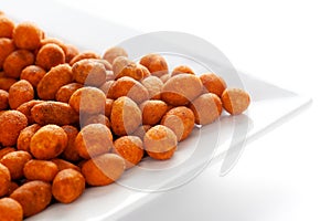 Crunchy Peanut in a white ceramic square plate, made with besan coated peanuts.