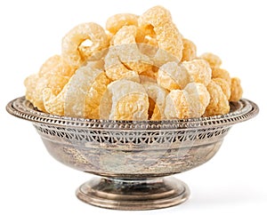 Crunchy Pork Cracklings in a Metal Bowl Isolated on White