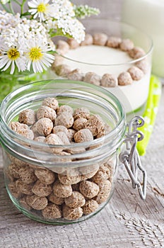 Crunchy rye bran balls in a glass jar. Healthy snack. Old wooden background