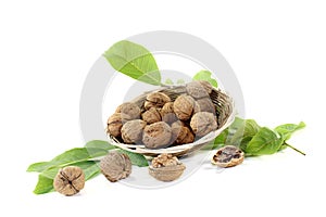 Crunchy walnuts with walnut leaves in a basket