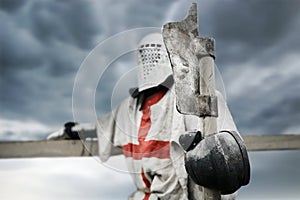 Crusader in armor holding axe.