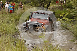 Crush Orange Jeep Rubicon crossing muddy pond