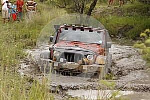 Crush Orange Jeep Rubicon crossing muddy pond