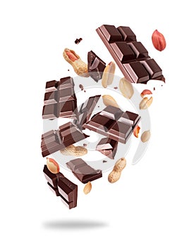 Crushed bar of dark chocolate with peanuts in the air isolated on a white background