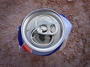 Crushed Can on Ground Dirt as Trash Litter