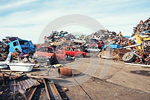 Crushed cars stacked up for recycling.