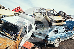 Crushed cars stacked up for recycling.