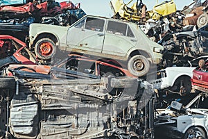 Crushed cars stacked up for recycling.