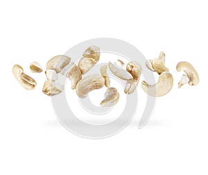 Crushed cashew nuts close-up hovered in white space