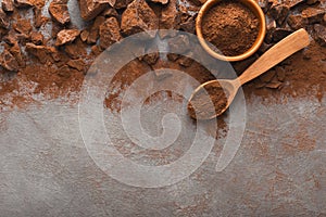 Crushed chocolate pieces on gray background, top view