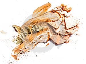 Crushed eyeshadow, powder and liquid foundation close-up isolated on white background