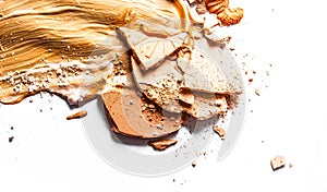 Crushed eyeshadow, powder and liquid foundation close-up isolated on white background