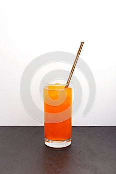 Crushed ice with red orange flavor. Orange granizado in tall glass. Vertical orientation, selective focus, copy space