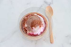 crushed ice Or shaved ice with sweet red water and sweetened condensed milk, Topped with chocolate powder, looks like a volcano.