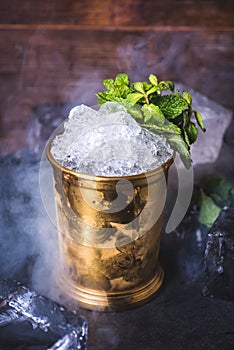 Crushed ice in a tin can on the table. photo