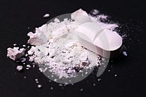 Crushed pill on a black background. Close-up. Drug abuse.