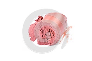 Crushed pink lipstick sample, isolated on white.