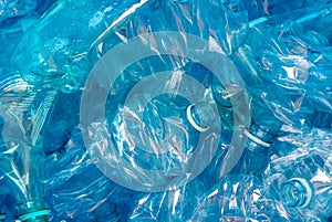 Crushed plastic bottles on blue background