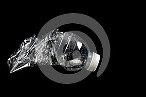 Crushed Plastic Mineral Water Bottle on a Black Background