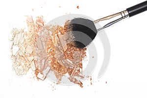 Crushed powder bronzer blush and powder brush on white background photo