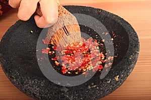Crushed red chilli paprikas in mortar