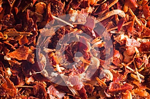 Crushed red hot peppers.Suns mixed with peel close-up background. Macro shooting