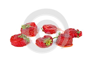 Crushed ripe uncultivated strawberries isolated on a white