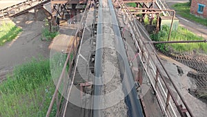 Crushed rock passing conveyor belt at mining industry. Aggregate transportation by conveyor belt at concrete mixing plant