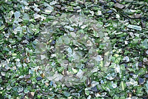 Crushed small pieces of glass are gathered for recycling in a machine in a recycling facility.