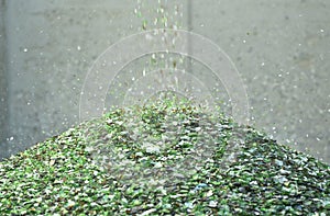 Crushed small pieces of glass are gathered for recycling in a machine in a recycling facility.