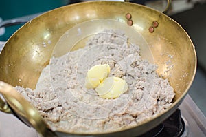 Crushed taro in brass pan prepare for making thai dessert